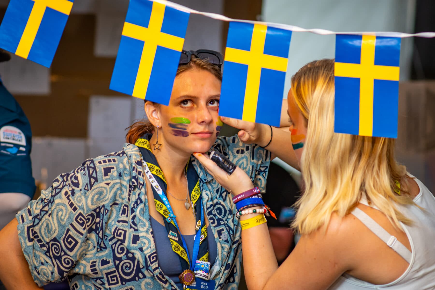 Participant doing a face painting in preparation for the pride festival.